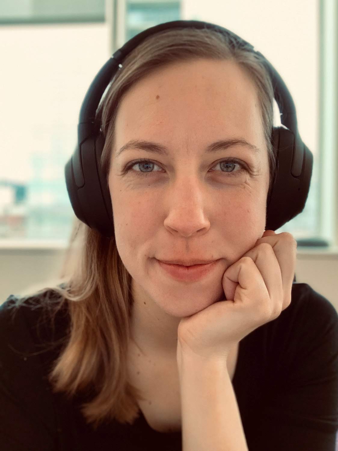 Portrait of Alyssa Hursh listening to noise-canceling headphones, used as a stand-in image to represent her work as a software engineer, lol