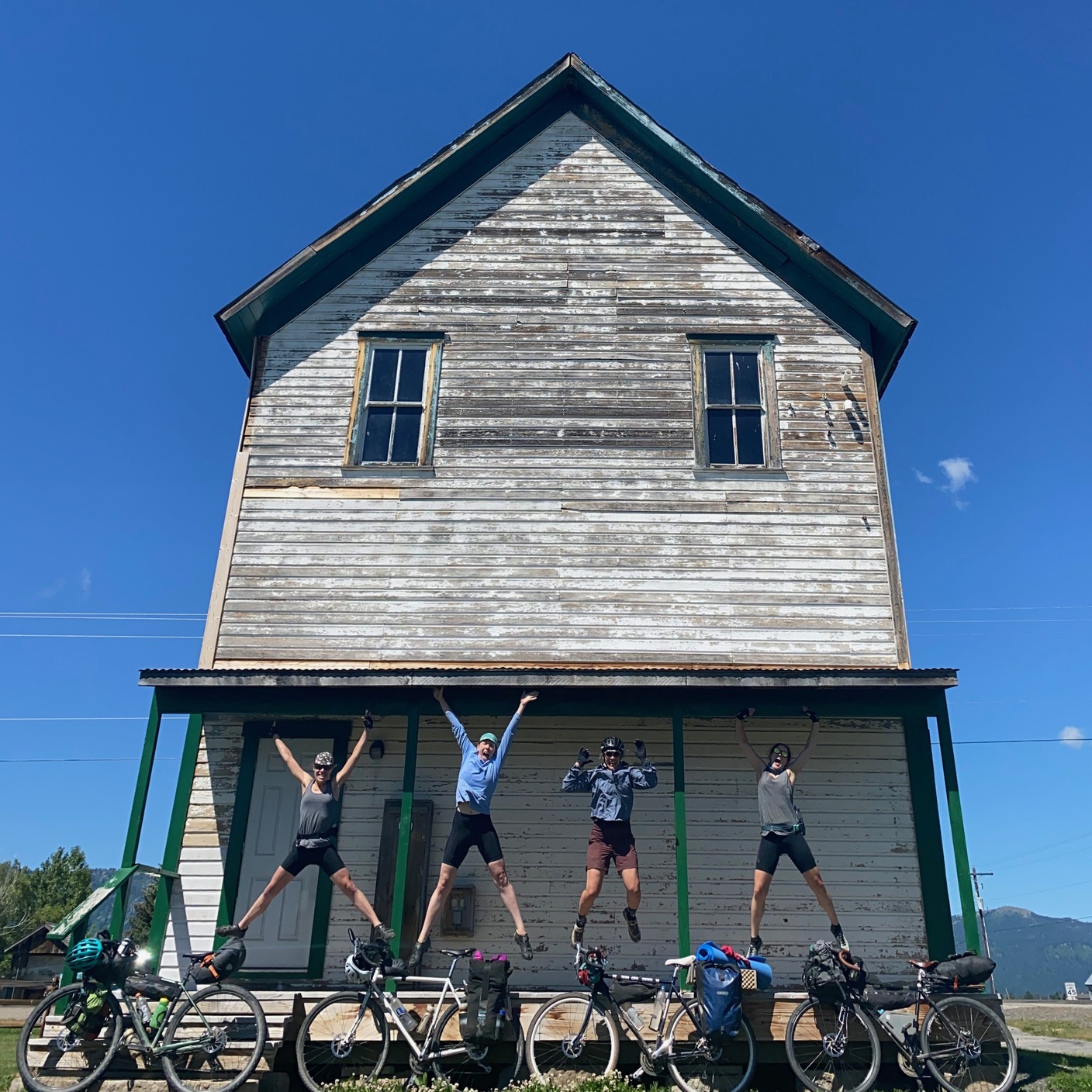 Alyssa Hursh and friends jumping in front of an old building in Idaho