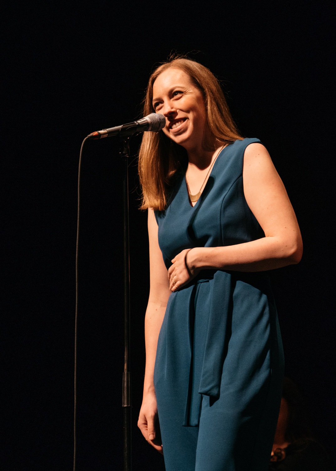 Alyssa Hursh telling a on the Moth Mainstage in Anchorage, Alaska